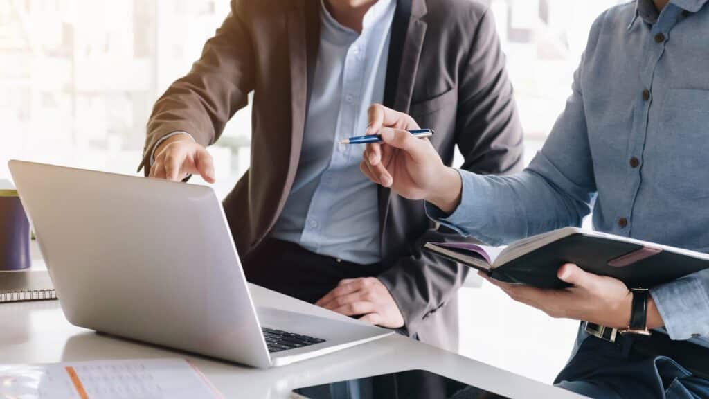 Two men checking trust documentation