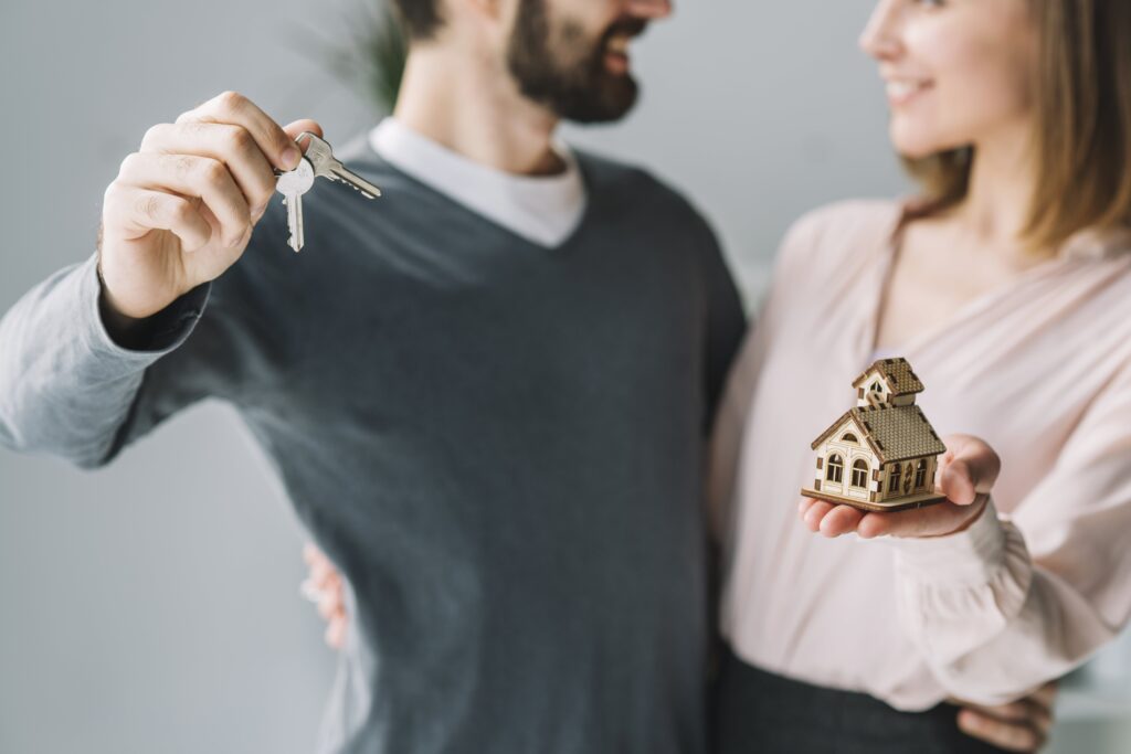 Happy couple with house keys